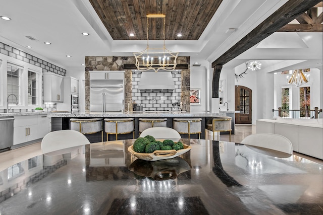 1031 Fish Trap Shls, Greensboro, GA 30642 - dining space featuring a chandelier, a tray ceiling, arched walkways, recessed lighting, and wood ceiling