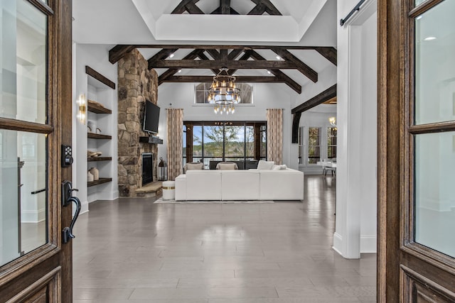 1031 Fish Trap Shls, Greensboro, GA 30642 - foyer entrance with beam ceiling, a chandelier, a stone fireplace, wood finished floors, and high vaulted ceiling