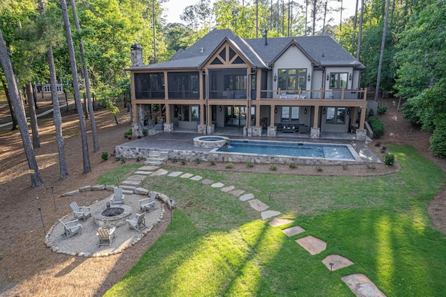 1031 Fish Trap Shls, Greensboro, GA 30642 - rear view of property featuring a fire pit, a sunroom, a patio area, a lawn, and a shingled roof