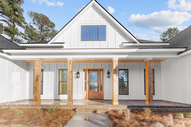 view of exterior entry featuring covered porch