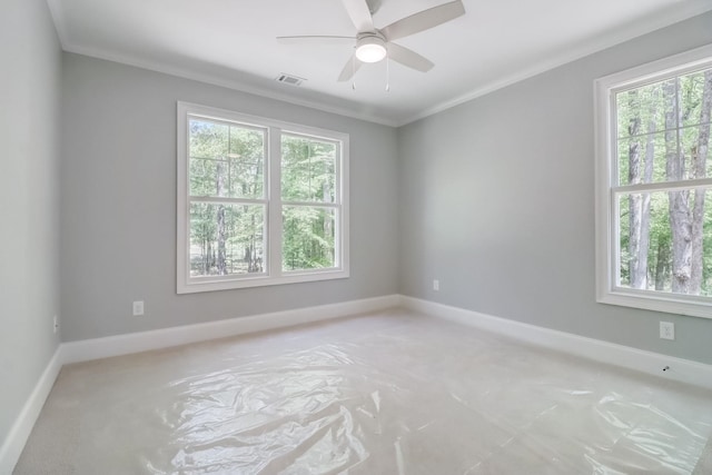 unfurnished room featuring crown molding, a wealth of natural light, and ceiling fan