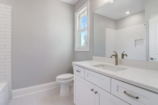 bathroom featuring vanity, tile patterned floors, and toilet