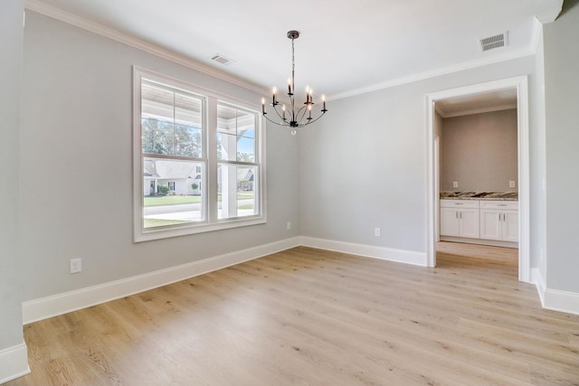 unfurnished dining area with crown molding, an inviting chandelier, and light hardwood / wood-style floors