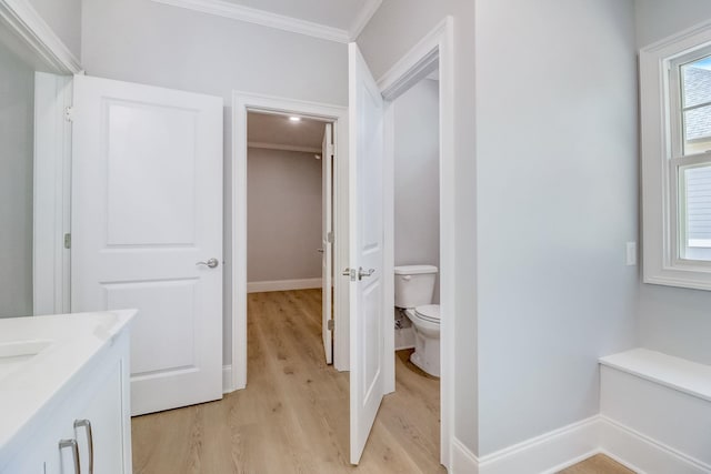 bathroom featuring ornamental molding, toilet, hardwood / wood-style floors, and vanity