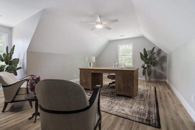 home office featuring vaulted ceiling, ceiling fan, and light hardwood / wood-style floors