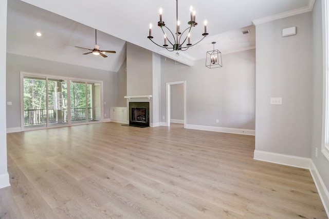 unfurnished living room with ceiling fan with notable chandelier, high vaulted ceiling, and light wood-type flooring