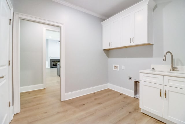 washroom with washer hookup, sink, light hardwood / wood-style flooring, and hookup for an electric dryer