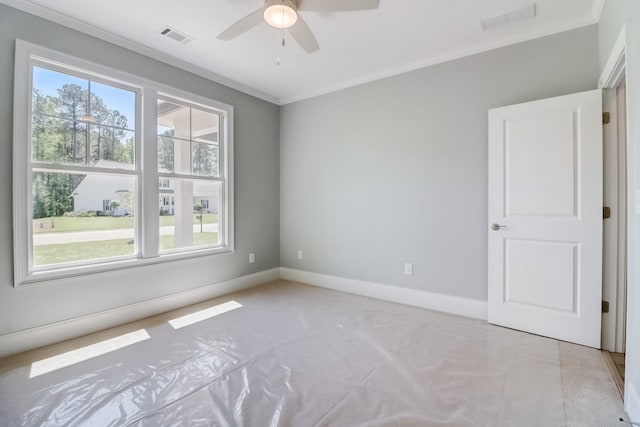 spare room featuring ornamental molding and ceiling fan