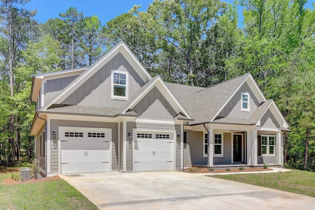 craftsman-style home with cooling unit and a garage