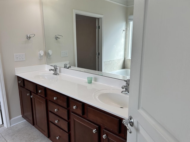 bathroom with tile patterned flooring, vanity, and a bath