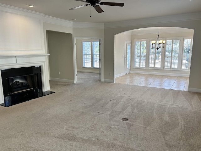 unfurnished living room featuring crown molding, light colored carpet, and ceiling fan with notable chandelier