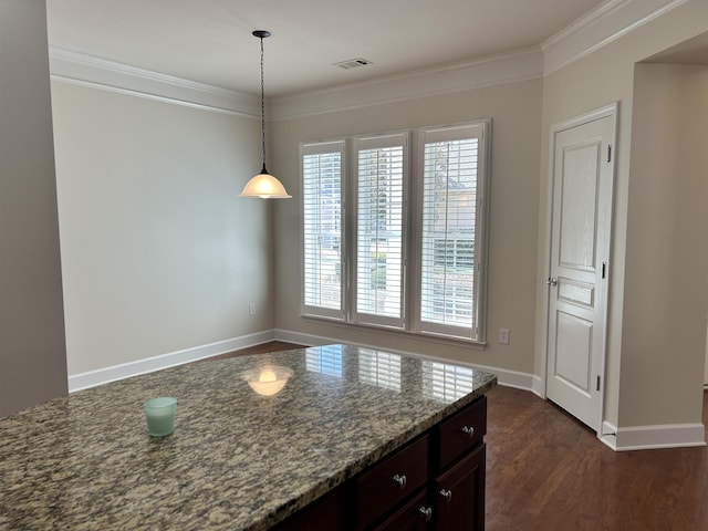 kitchen featuring stone counters, pendant lighting, dark wood-type flooring, crown molding, and dark brown cabinets