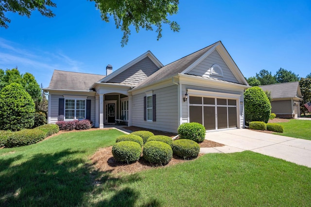 view of front of house with a garage and a front yard