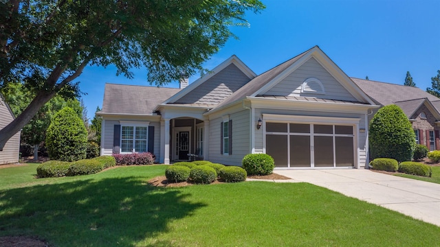 view of front of home featuring a garage and a front lawn