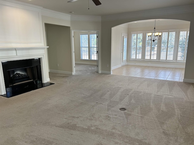 unfurnished living room featuring light carpet, ceiling fan with notable chandelier, and ornamental molding