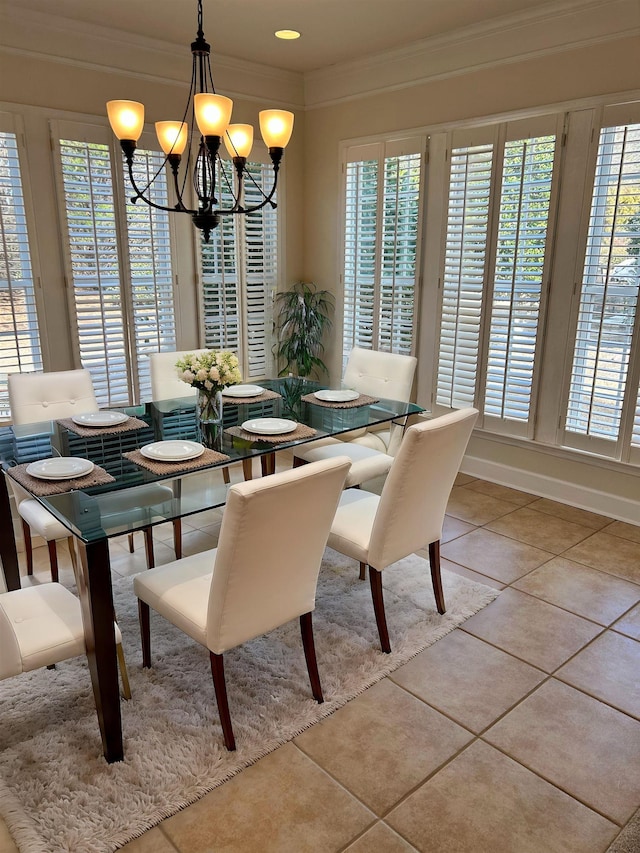 tiled dining area with ornamental molding and a wealth of natural light