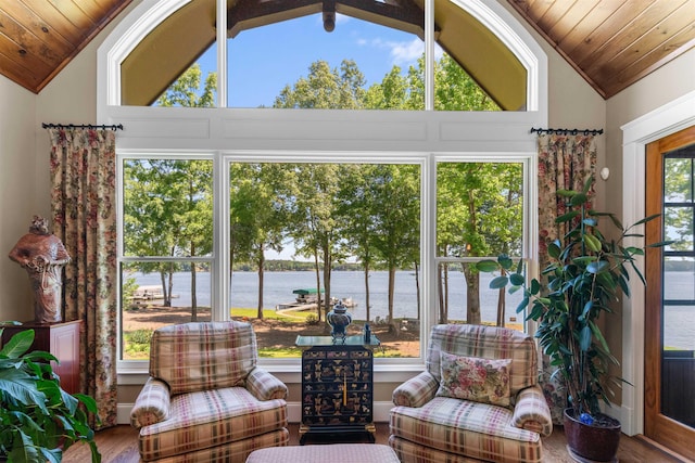 sunroom / solarium featuring vaulted ceiling, a water view, wood ceiling, and wood finished floors