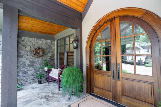 doorway to property featuring stone siding