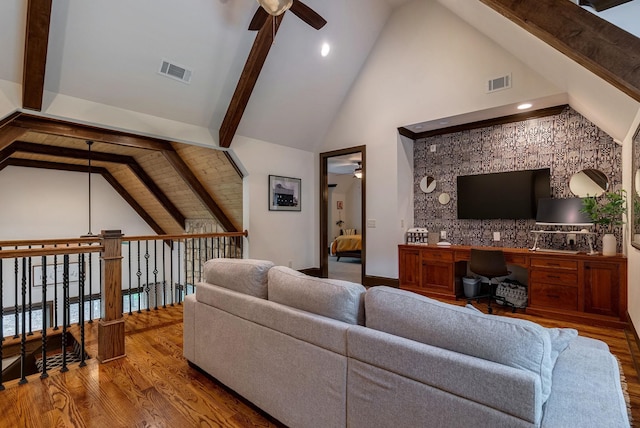 146 Long Island Dr, Eatonton, GA 31024 - living room featuring ceiling fan, wood finished floors, built in desk, beamed ceiling, and high vaulted ceiling