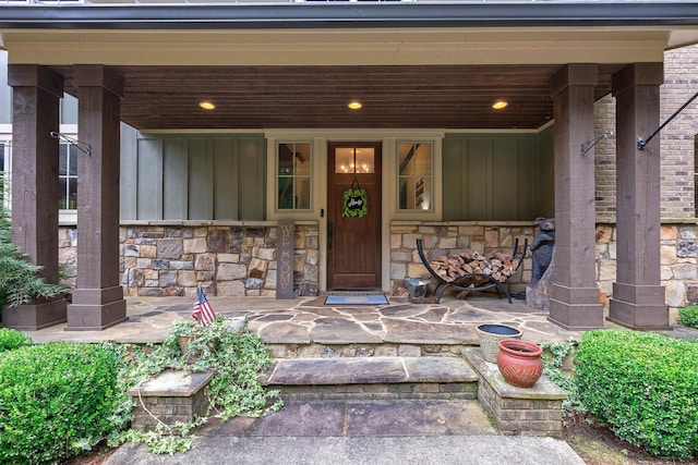 146 Long Island Dr, Eatonton, GA 31024 - entrance to property featuring board and batten siding, stone siding, and a porch