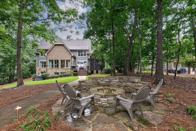 146 Long Island Dr, Eatonton, GA 31024 - view of patio with a sunroom and an outdoor fire pit