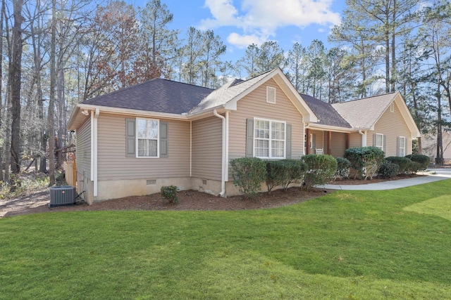 ranch-style home with crawl space, central AC, a front lawn, and roof with shingles