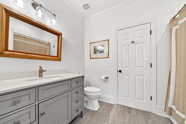 bathroom with hardwood / wood-style flooring, vanity, ornamental molding, curtained shower, and toilet