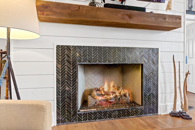 details with hardwood / wood-style floors and a fireplace