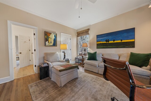 living room with ceiling fan, ornamental molding, and hardwood / wood-style floors