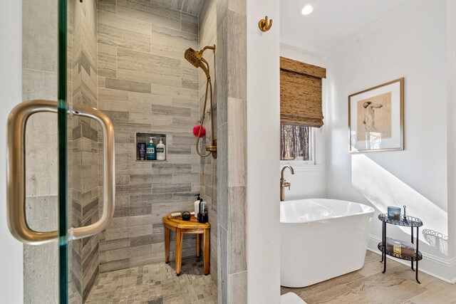 bathroom with independent shower and bath and ornamental molding