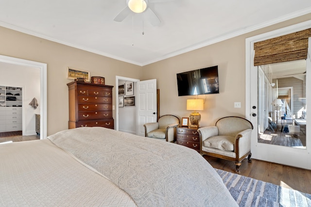 bedroom featuring dark wood-type flooring, ceiling fan, and ornamental molding