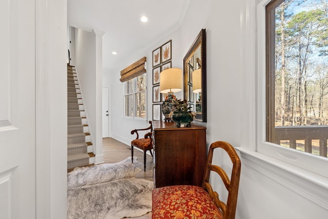 corridor featuring hardwood / wood-style flooring and crown molding