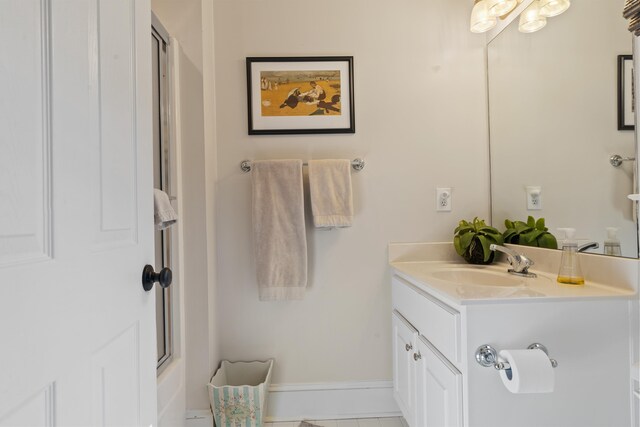 bathroom with vanity and combined bath / shower with glass door