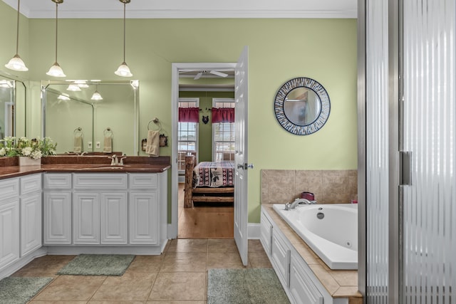 bathroom with tile patterned floors, crown molding, vanity, a relaxing tiled tub, and ceiling fan