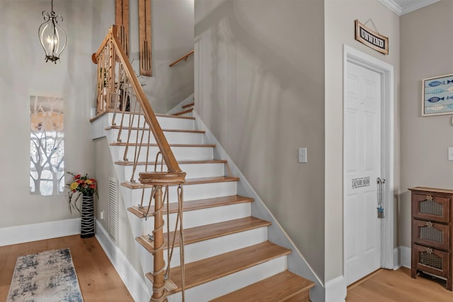 staircase with hardwood / wood-style flooring