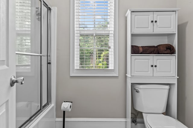 163 Knight Dr, Milledgeville, GA 31061 - bathroom featuring healthy amount of natural light, toilet, and combined bath / shower with glass door