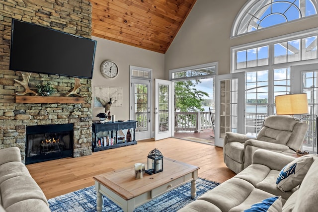 163 Knight Dr, Milledgeville, GA 31061 - living area with high vaulted ceiling, plenty of natural light, wood finished floors, a fireplace, and wooden ceiling