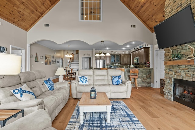163 Knight Dr, Milledgeville, GA 31061 - living room featuring a chandelier, light wood-type flooring, high vaulted ceiling, wooden ceiling, and arched walkways