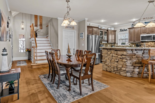 163 Knight Dr, Milledgeville, GA 31061 - dining room featuring ornamental molding, light wood-style floors, stairway, a chandelier, and baseboards
