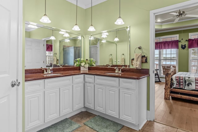 bathroom featuring ceiling fan, ornamental molding, tile patterned flooring, and vanity