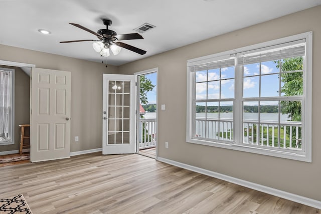 163 Knight Dr, Milledgeville, GA 31061 - unfurnished room with baseboards, light wood finished floors, ceiling fan, and a water view