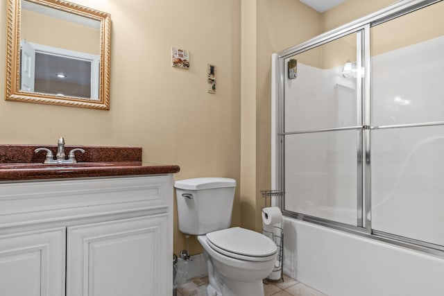 full bathroom with vanity, tile patterned floors, toilet, and combined bath / shower with glass door