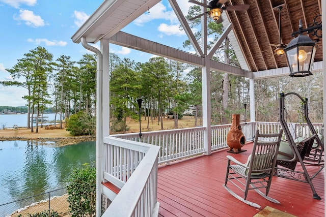 wooden terrace featuring ceiling fan and a water view