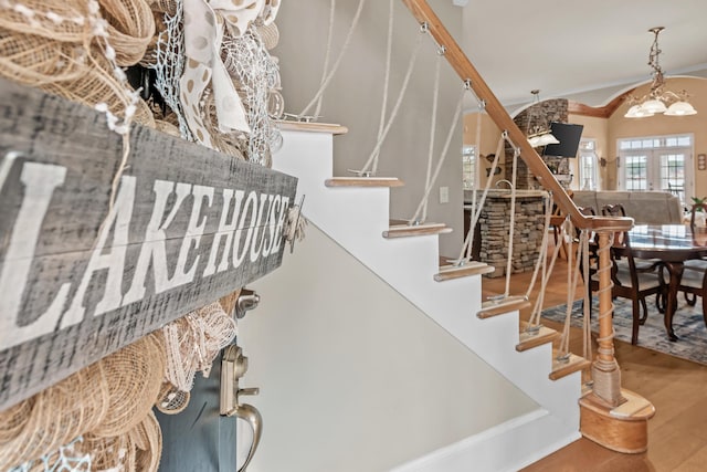 stairs featuring vaulted ceiling, wood-type flooring, and french doors