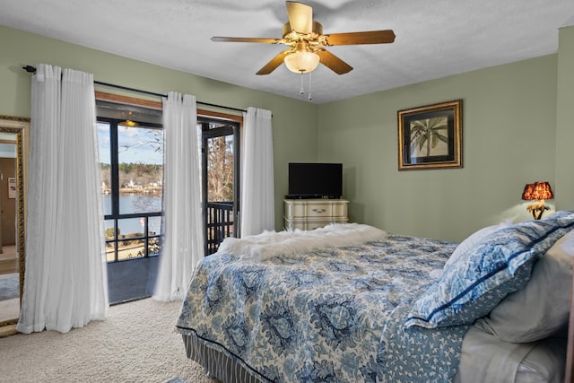 carpeted bedroom featuring ceiling fan, a textured ceiling, and access to outside