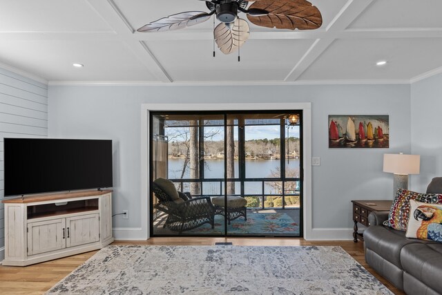 living room featuring a water view, ceiling fan, coffered ceiling, and light hardwood / wood-style floors