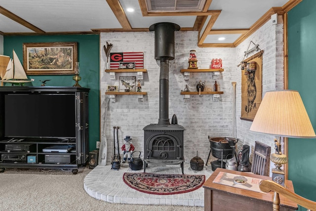 carpeted living room with brick wall, beam ceiling, and a wood stove