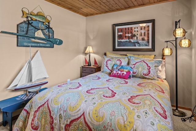 bedroom with carpet flooring and wooden ceiling