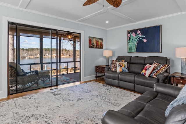 living room with ceiling fan, hardwood / wood-style floors, a water view, coffered ceiling, and ornamental molding