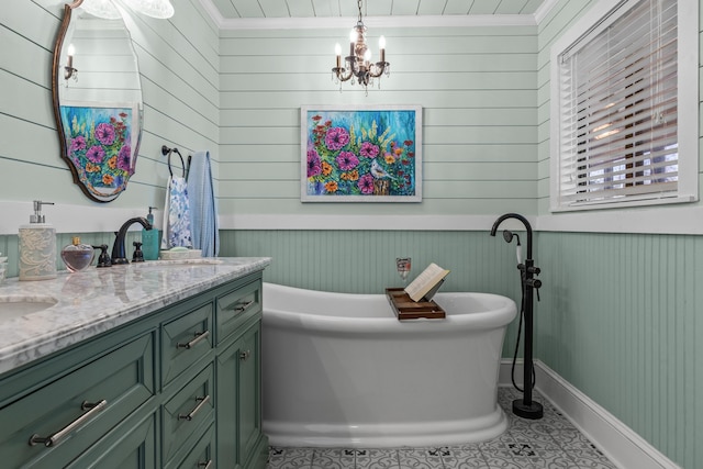 bathroom with crown molding, vanity, a notable chandelier, a tub to relax in, and tile patterned floors